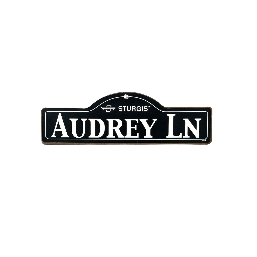 Audrey Sturgis wooden street name sign with white lettering on black