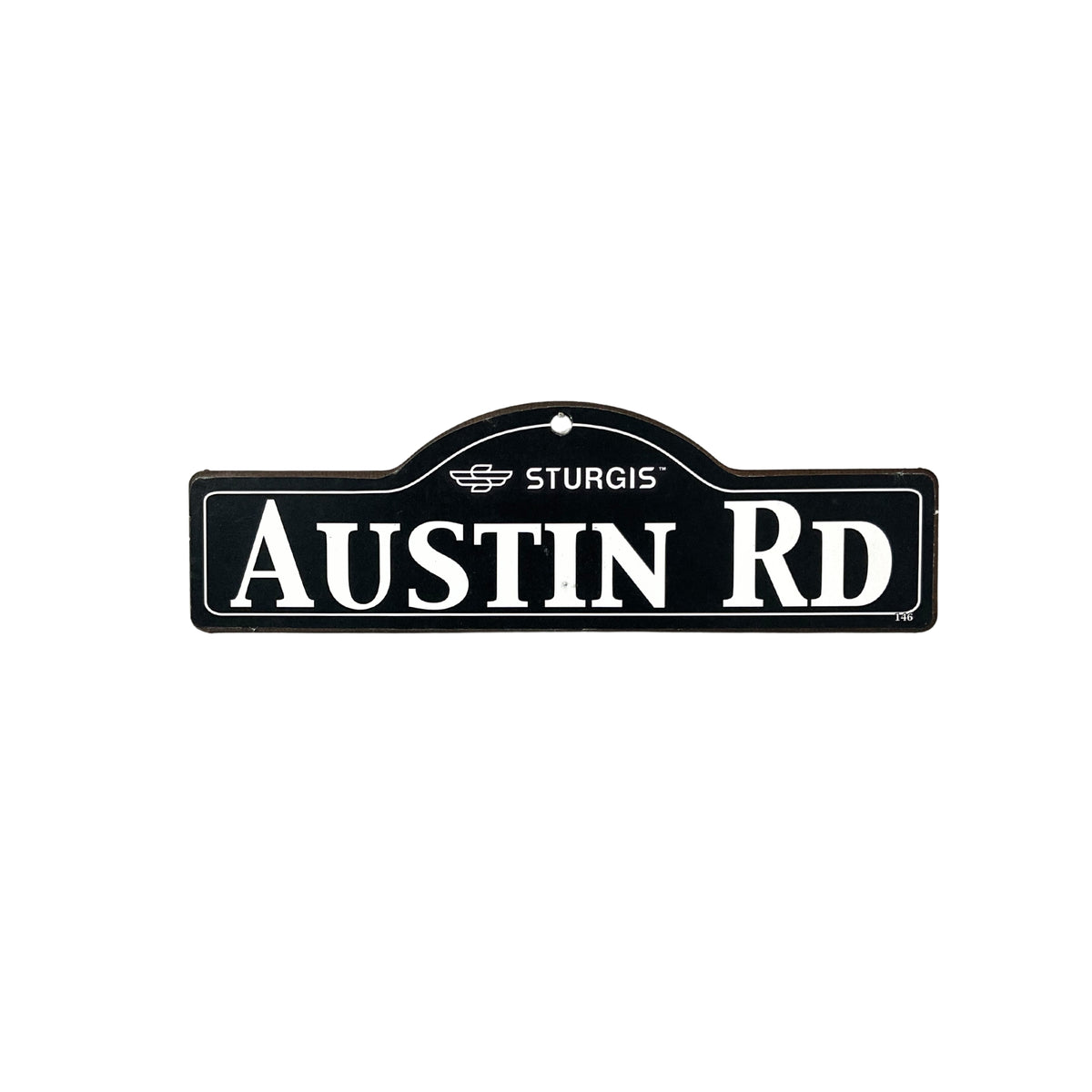 Austin Sturgis wooden street name sign with white lettering on black