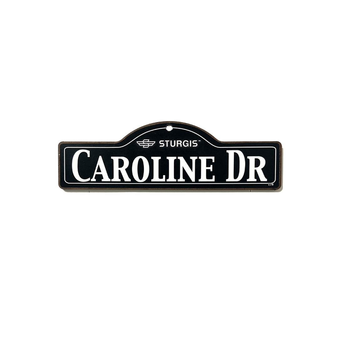 Caroline Sturgis wooden street name sign with white lettering on black