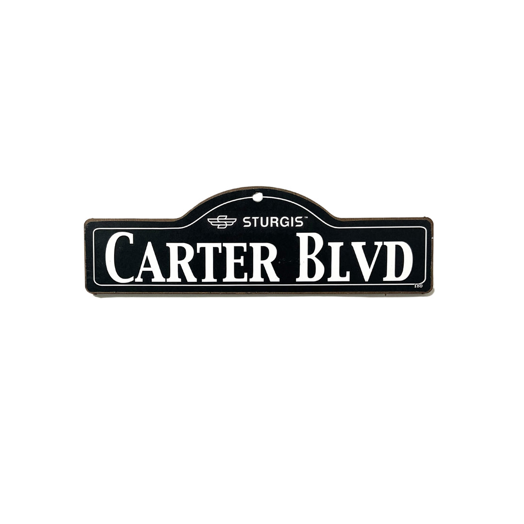 Carter Sturgis wooden street name sign with white lettering on black
