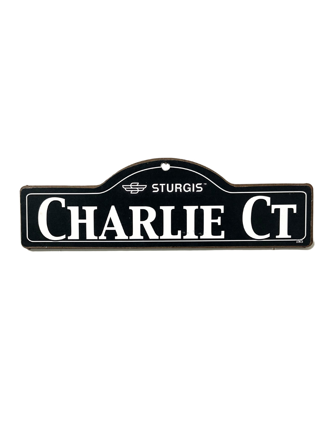 Charlie Sturgis wooden street name sign with white lettering on black