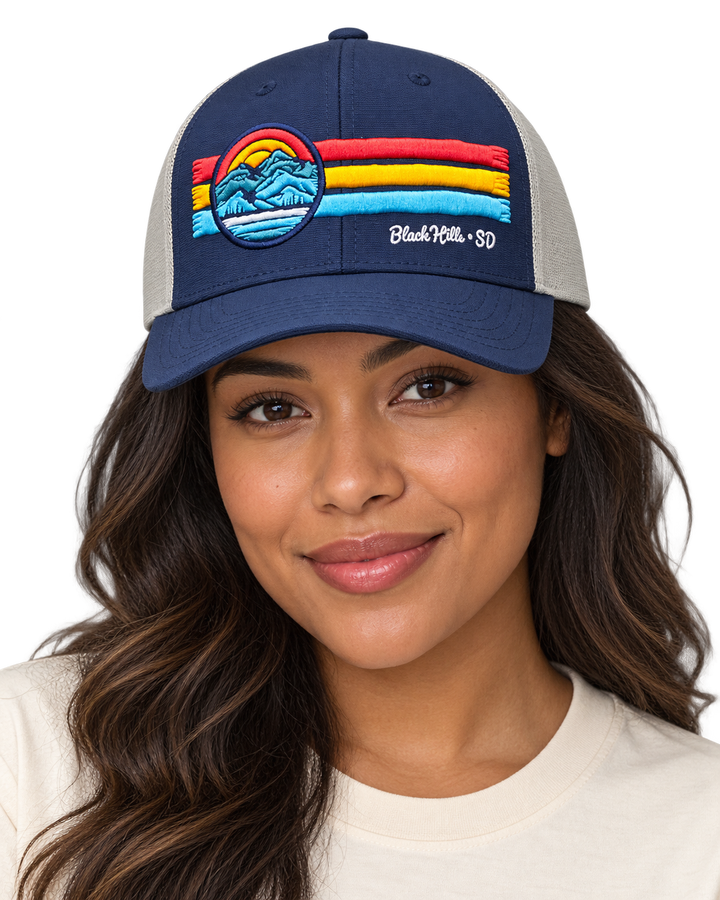 Woman wearing navy and gray Black Hills retro mountain hat