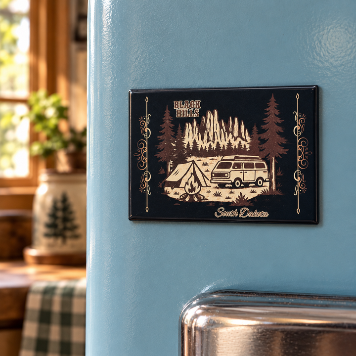 Black Hills camper van and campfire magnet on a blue vintage refrigerator