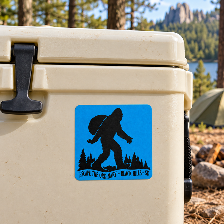 Black Hills Escape the Ordinary Bigfoot Backpacker Sticker on a cooler — lifestyle display mockup; accessories not included