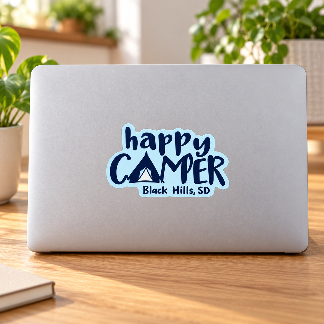 Black Hills Happy Camper Tent Lettering Sticker on a laptop — lifestyle display mockup