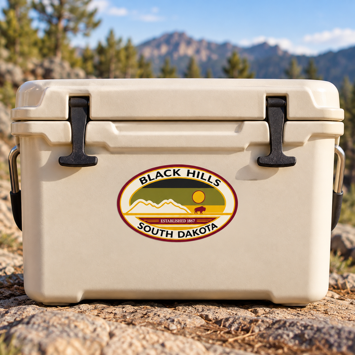 Black Hills Heritage Mountain &amp; Bison Oval Sticker on a cooler — lifestyle display mockup; accessories not included