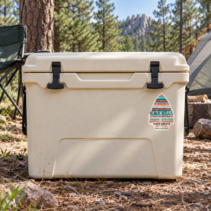 Black Hills Pastel Stripe Arrowhead Sticker on a camping cooler — realistic scale lifestyle display; accessories not included