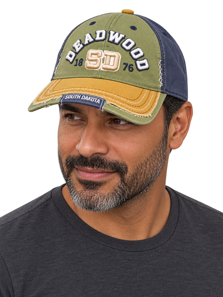 Man wearing the olive, navy and mustard Deadwood raised embroidery hat