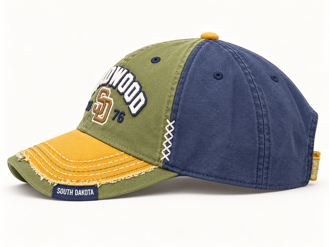 Side view of Deadwood hat showing olive and navy panels and decorative white cross stitches