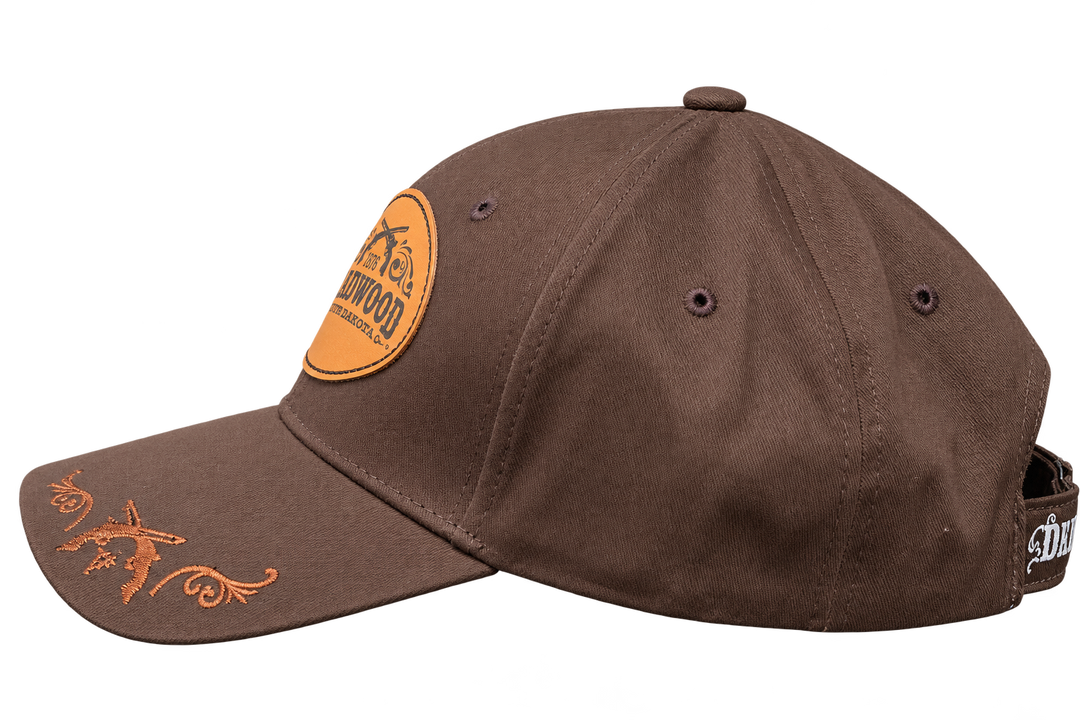 Brown Deadwood 1876 leather patch hat, side view with tan embroidered brim