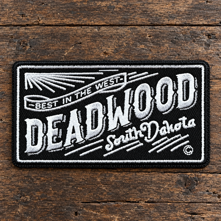 Deadwood Best in the West Embroidered Patch — on weathered wood