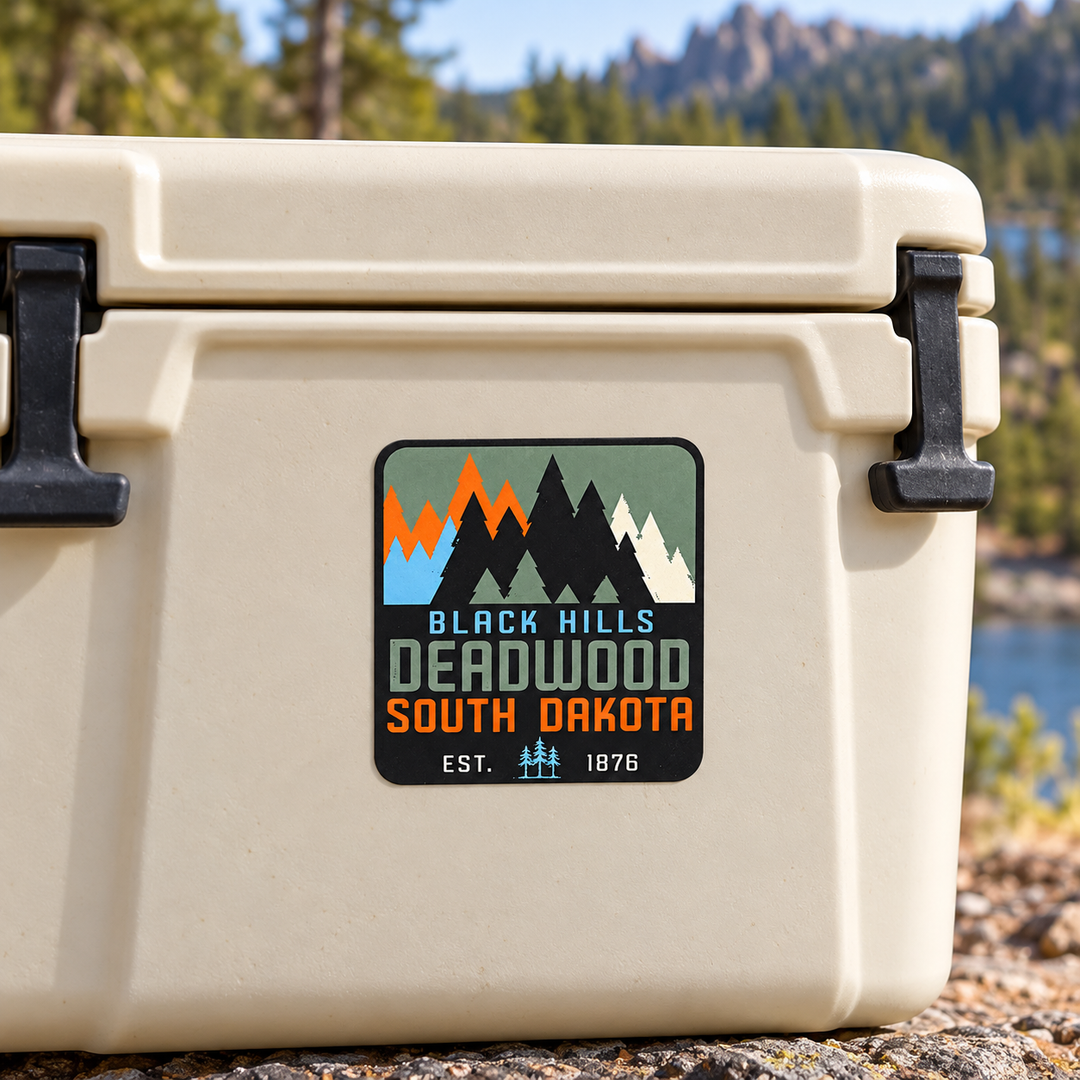Deadwood Black Hills Colorblock Pine Trees Sticker on a cooler — lifestyle display mockup; accessories not included