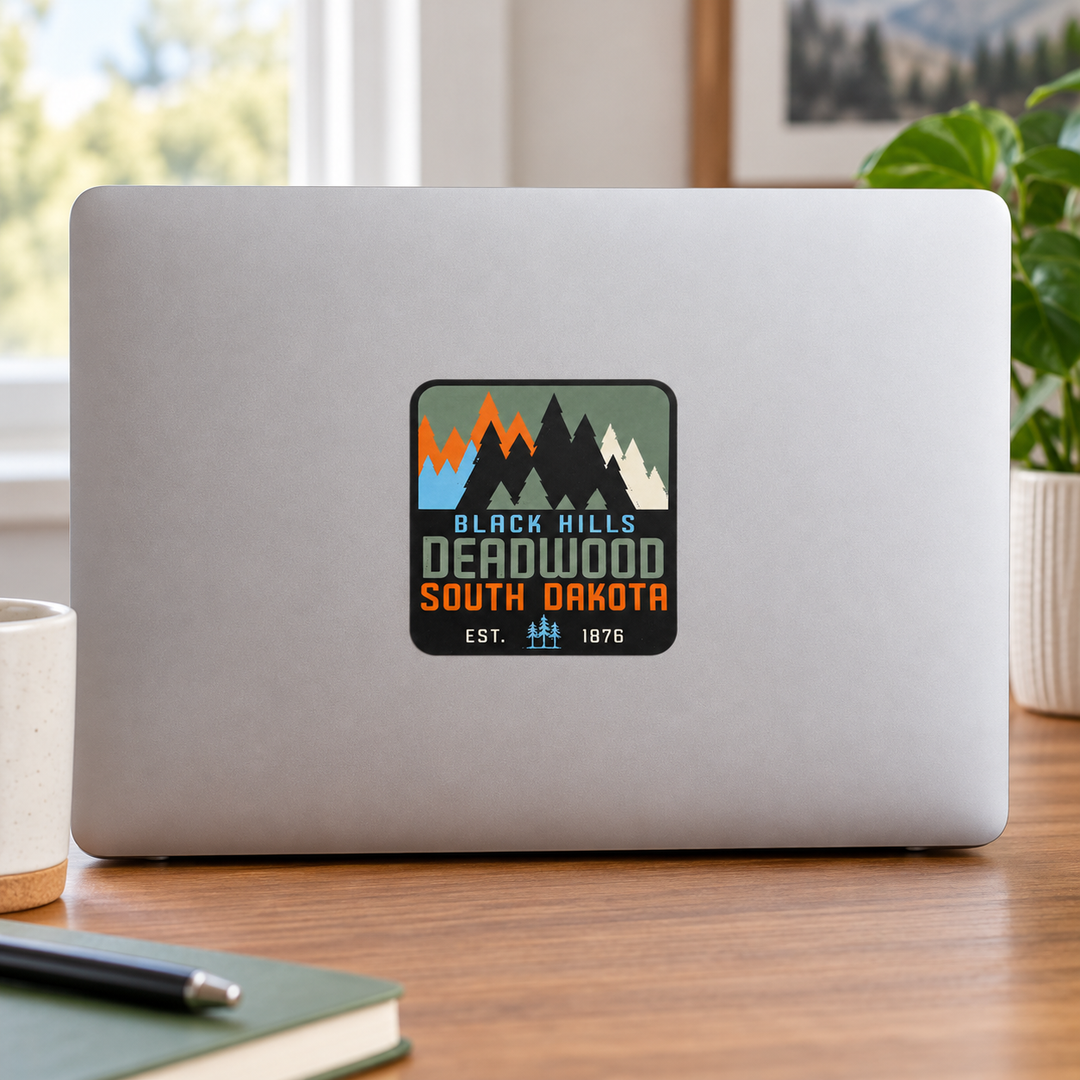 Deadwood Black Hills Colorblock Pine Trees Sticker on a laptop — lifestyle display mockup; accessories not included