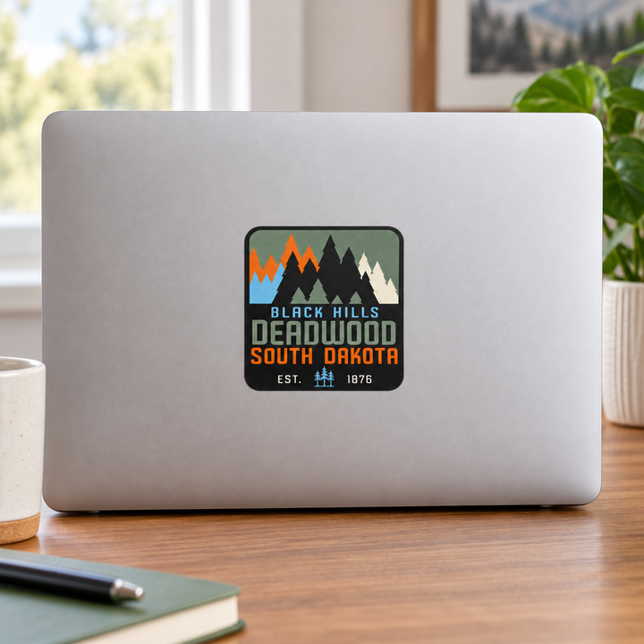 Deadwood Black Hills Colorblock Pine Trees Sticker on a laptop — lifestyle display mockup; accessories not included