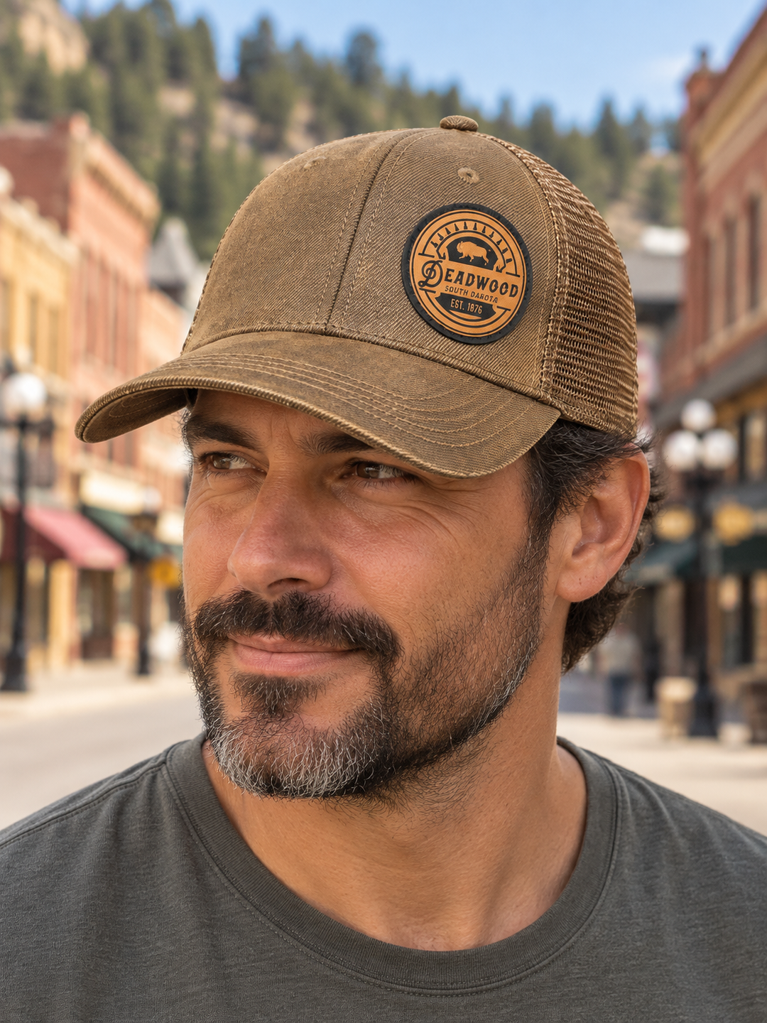 Deadwood Buffalo Heritage Leather Patch Trucker Hat – Washed Brown; male model wearing hat (AI-generated lifestyle image)