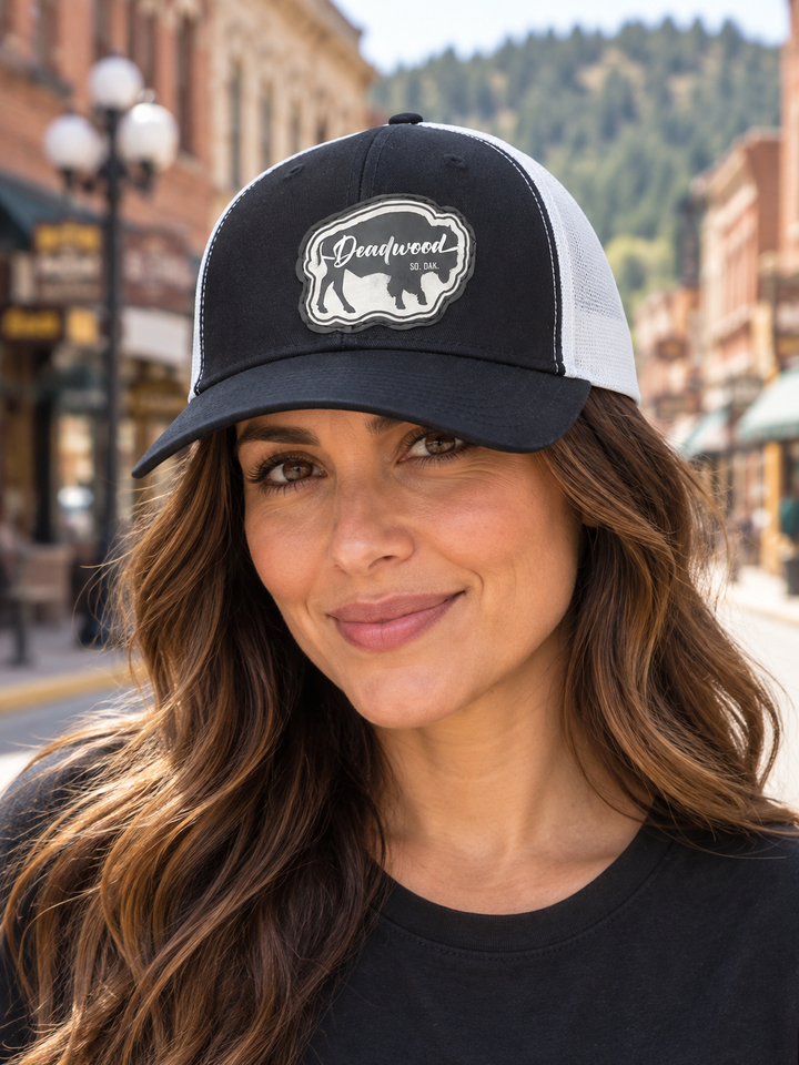 Deadwood Buffalo Silhouette Leather Patch Trucker Hat – Black &amp; White; female model wearing hat (AI-generated lifestyle image)