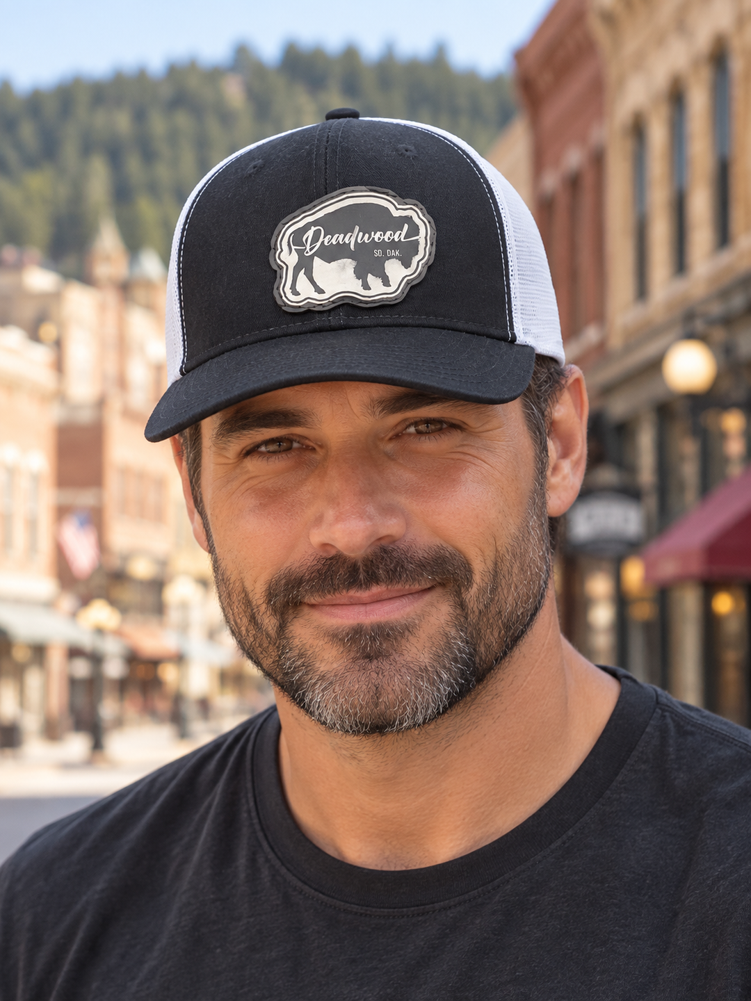 Deadwood Buffalo Silhouette Leather Patch Trucker Hat – Black &amp; White; male model wearing hat (AI-generated lifestyle image)