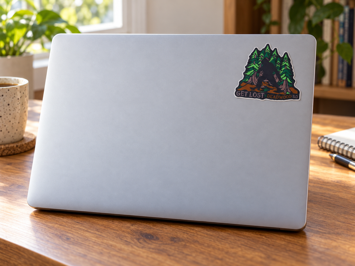 Deadwood Get Lost Bigfoot Pine Forest Sticker on a laptop cover at realistic scale