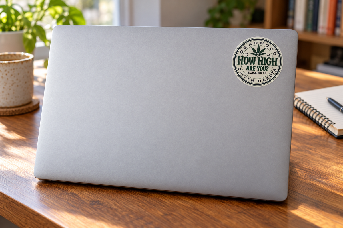 Deadwood How High Are You Cannabis Leaf Round Sticker on a laptop cover at realistic scale