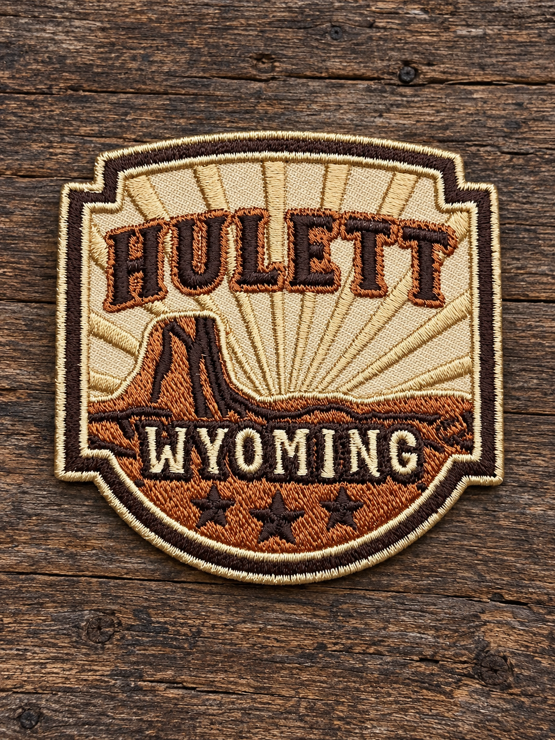 Hulett Wyoming Western Shield Embroidered Patch — on weathered wood