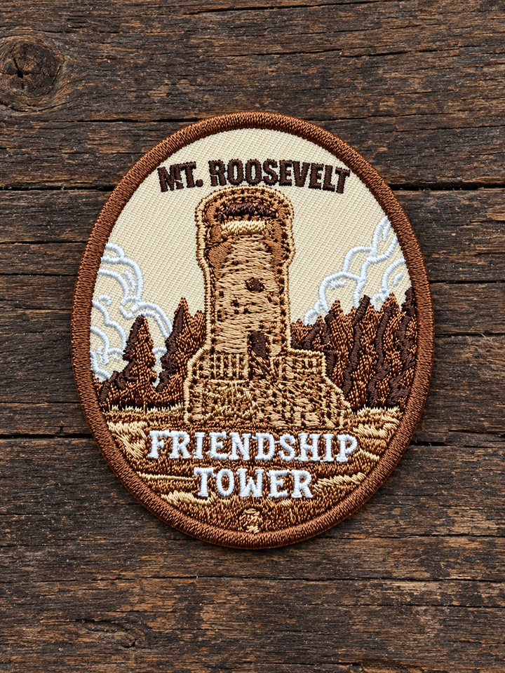 Mount Roosevelt Friendship Tower Embroidered Patch — on weathered wood