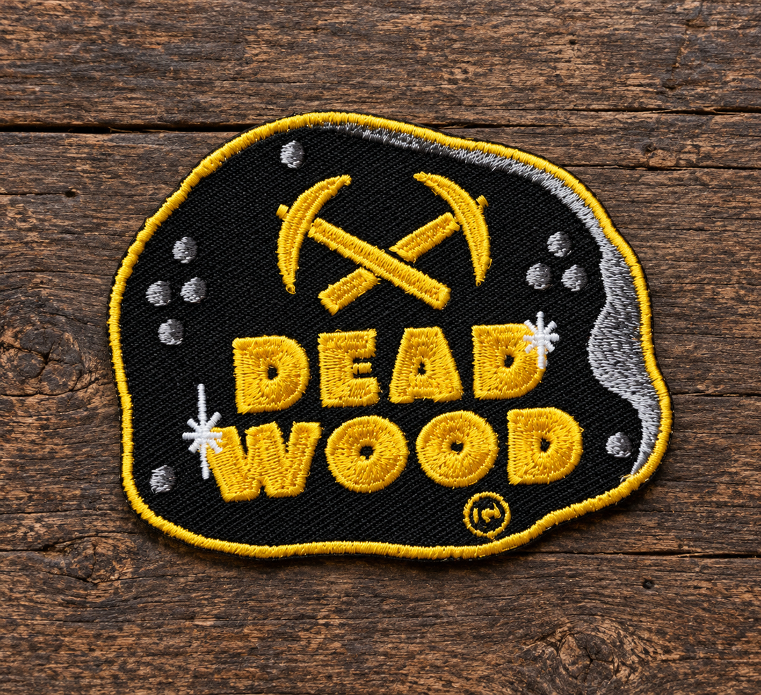 Deadwood Crossed Pickaxes Embroidered Patch — on weathered wood