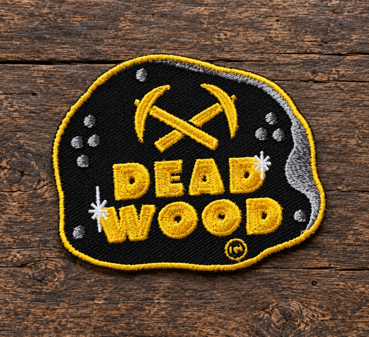 Deadwood Crossed Pickaxes Embroidered Patch — on weathered wood