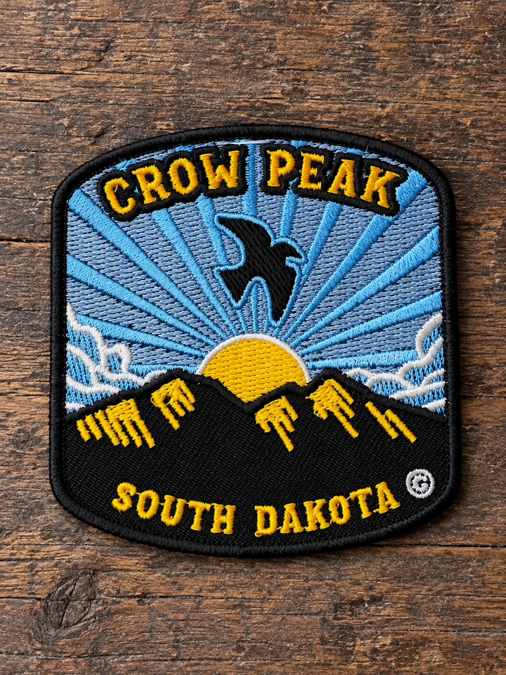 Crow Peak South Dakota Embroidered Patch — on weathered wood