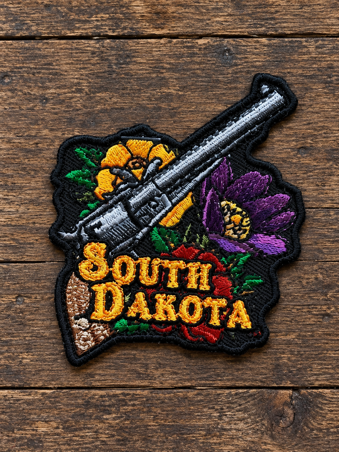 South Dakota Western Revolver &amp; Flowers Embroidered Patch — on weathered wood