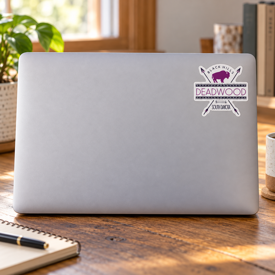 Deadwood Purple Bison &amp; Crossed Arrows Sticker on a laptop cover — realistic scale lifestyle display; accessories not included
