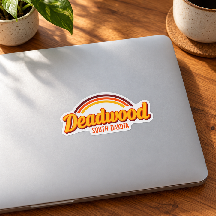 Deadwood Retro Rainbow Script Sticker on a laptop — lifestyle display mockup; accessories not included