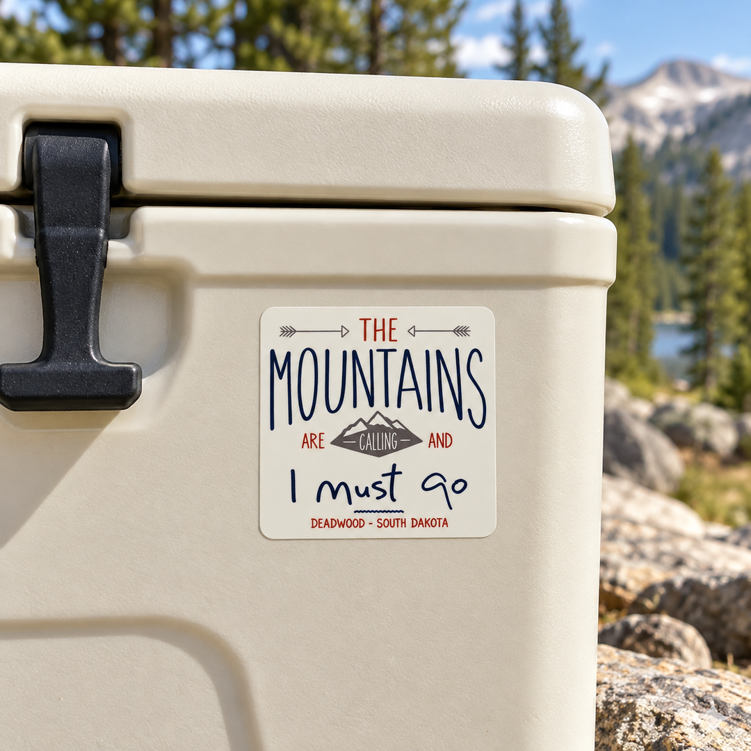 Deadwood The Mountains Are Calling Sticker on a cooler — lifestyle display mockup; accessories not included
