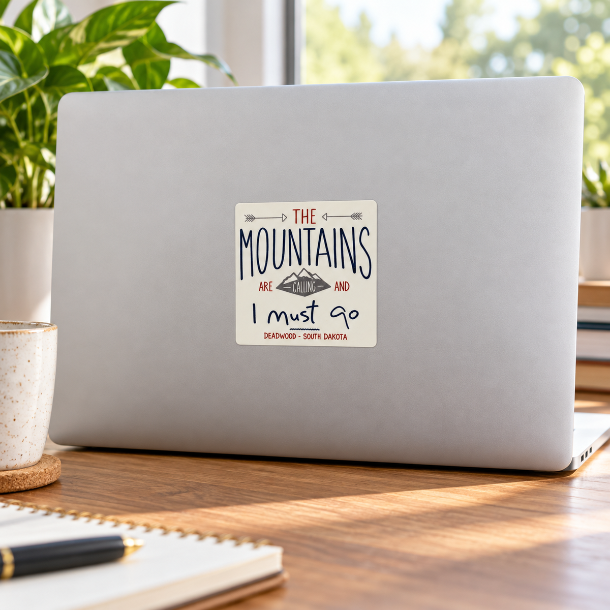 Deadwood The Mountains Are Calling Sticker on a laptop — lifestyle display mockup; accessories not included