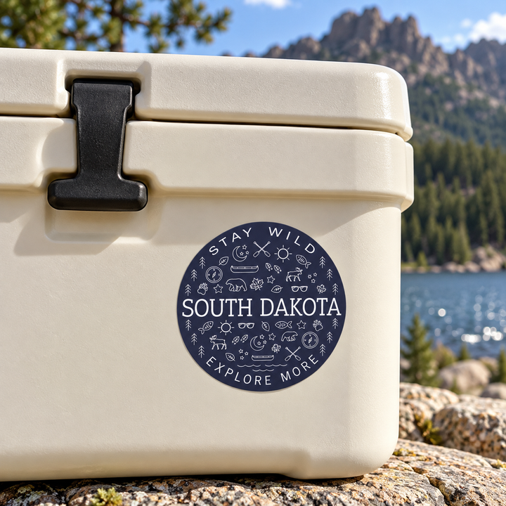 South Dakota Stay Wild Explore More Round Sticker on a cooler — lifestyle display mockup; accessories not included