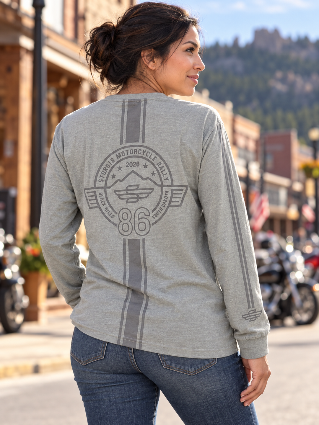 Sturgis 2026 official long sleeve shirt in Heather Gray Racing Stripes — female model back view