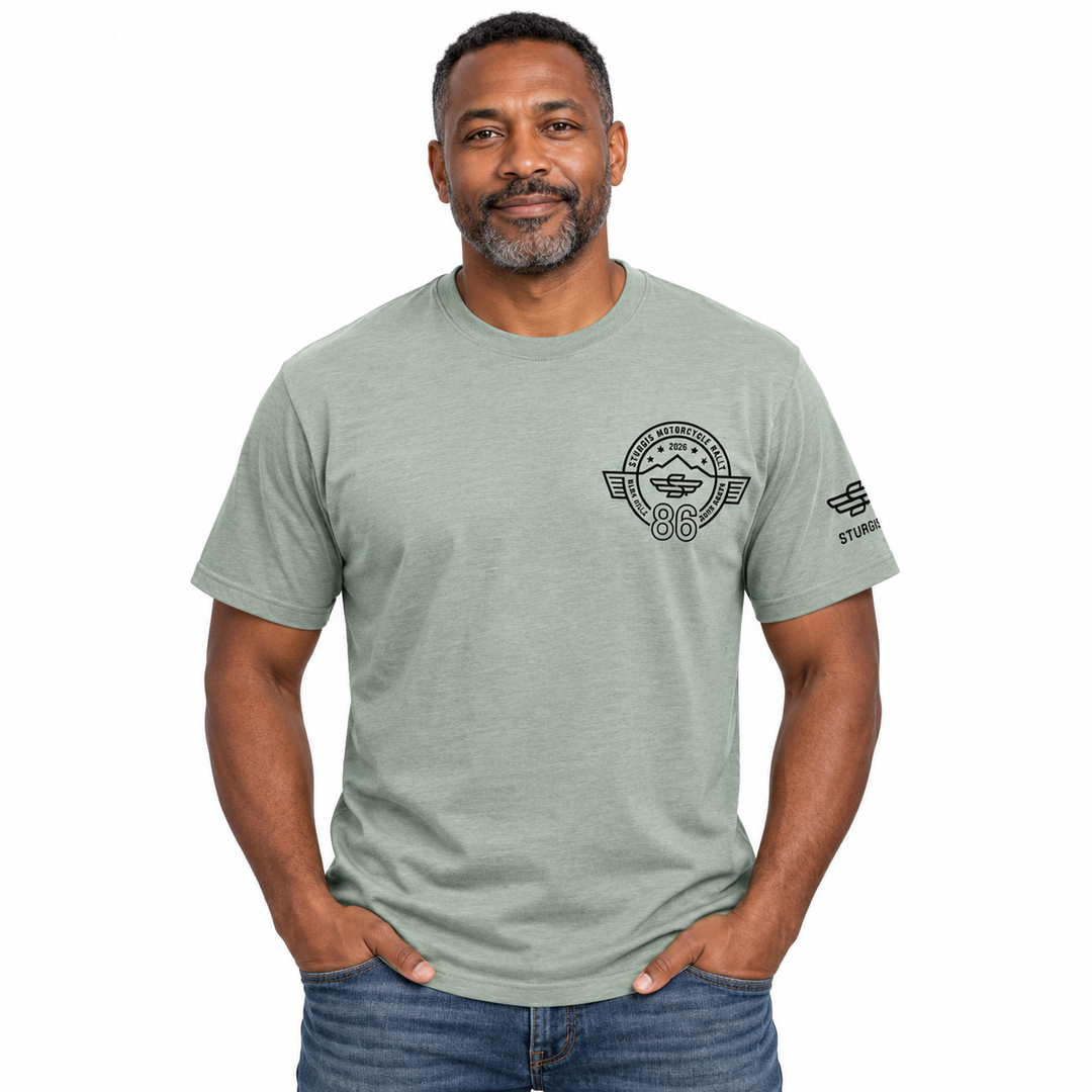 Sturgis 2026 official sage green T-shirt with black Winged-S 86th rally logo — model front view